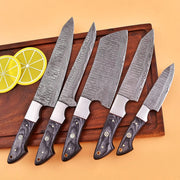 High-quality image of 5 pieces handcrafted damascus steel knife chef set with steel bolster, black wood handle and leather cullinary roll
