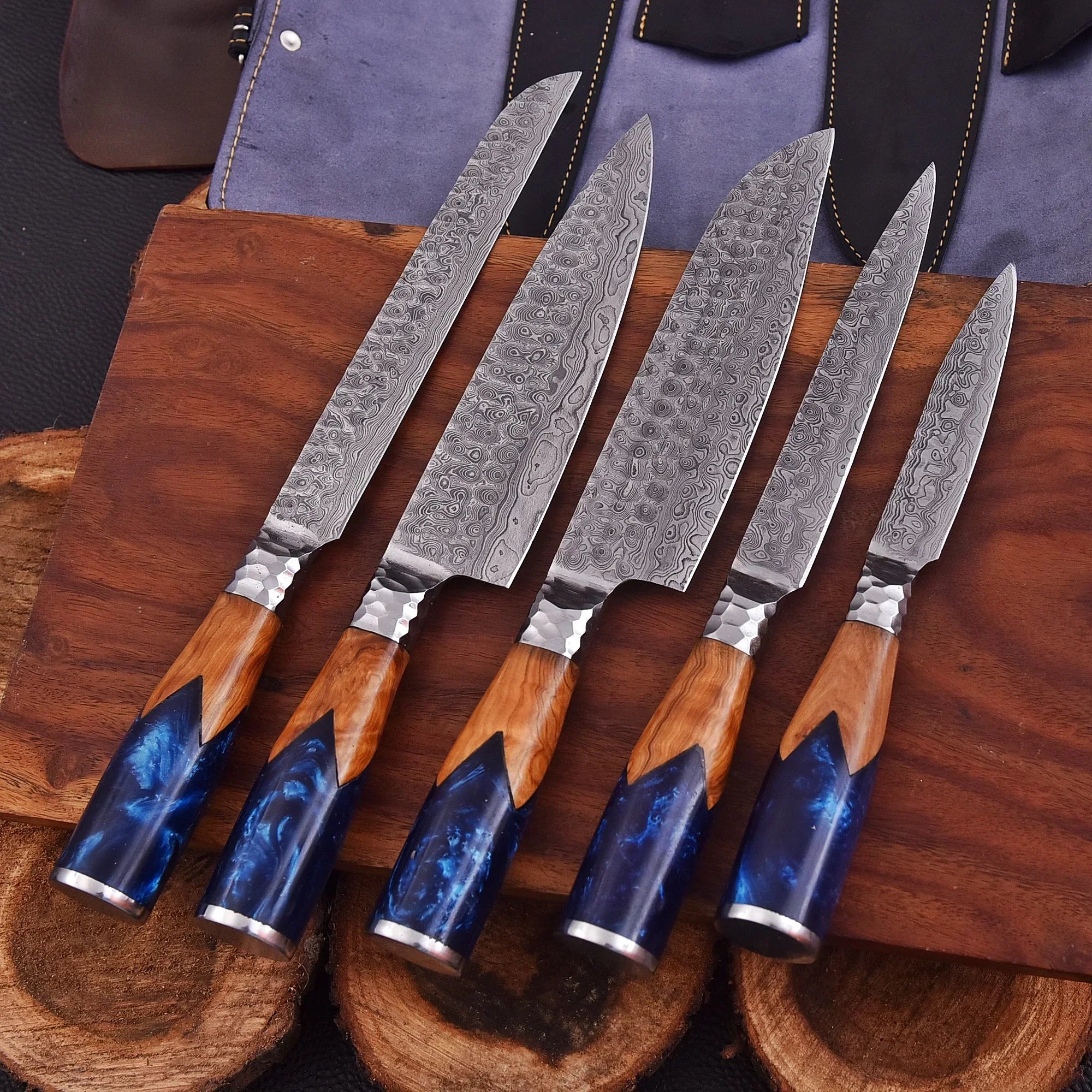 Handmade Oceanhearth Damascus Chef Set with natural wood and deep ocean resin handles – 5-piece collectible culinary set with leather roll.