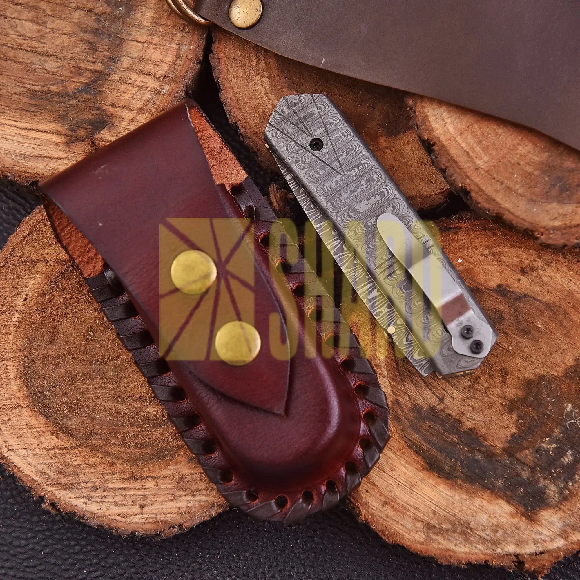 Crimson Crest Damascus Steel Folding Utility Craft with raindrop and wave pattern, featuring folding design and belt buckle clip.